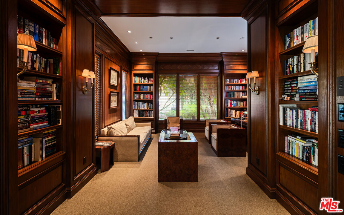 14035 Aubrey Road Beverly Hills, CA 90210 - Photo 9 of 24 a living room with furniture a bookshelf and a window