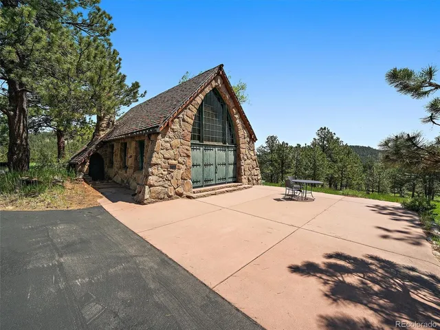 a living room with furniture a flat screen tv and kitchen view