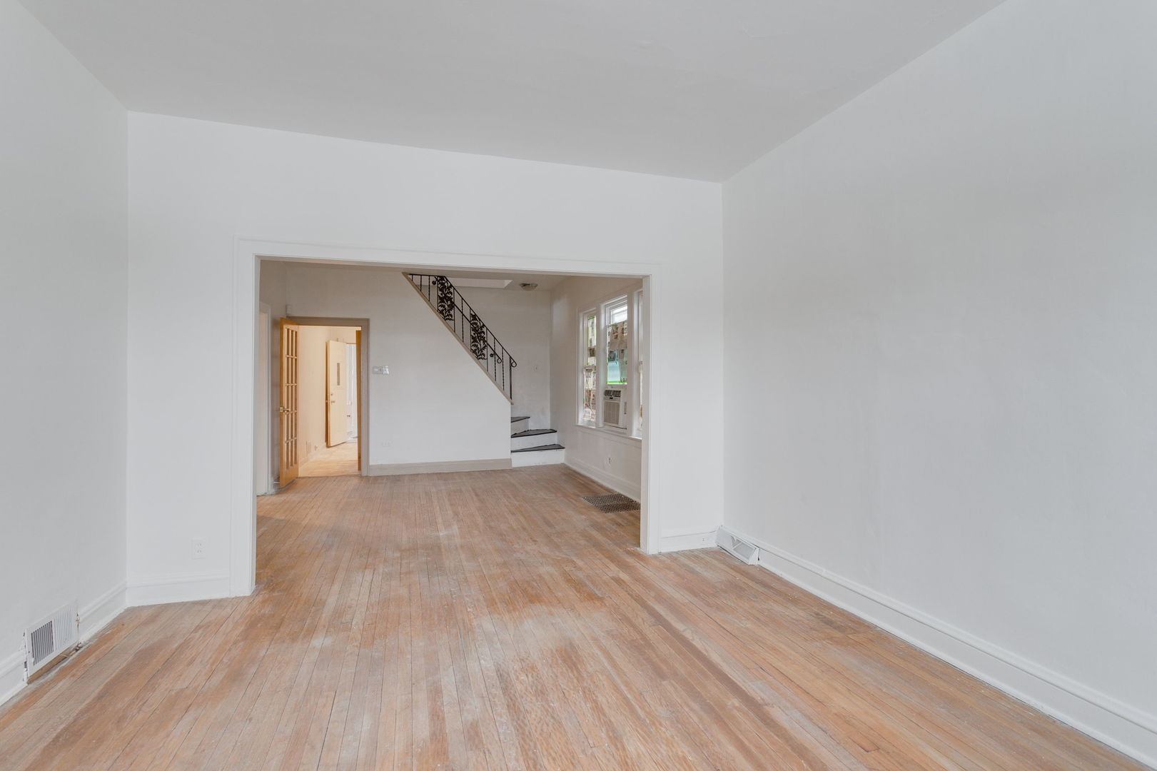 1404 West 97th Street Chicago, IL 60643 - Photo 3 of 13 an empty room with wooden floor and windows