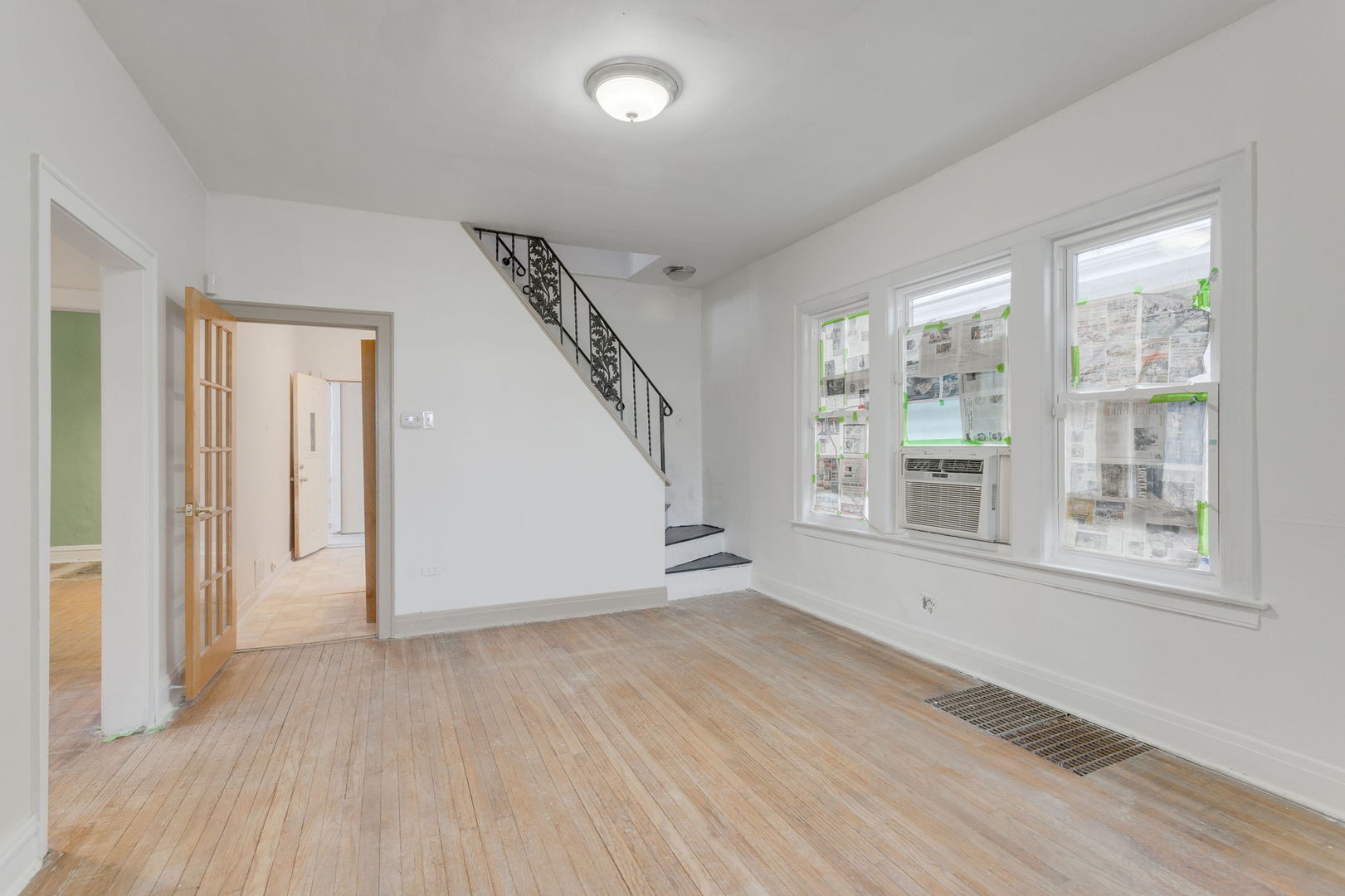 1404 West 97th Street Chicago, IL 60643 - Photo 6 of 13 an empty room with wooden floor and windows