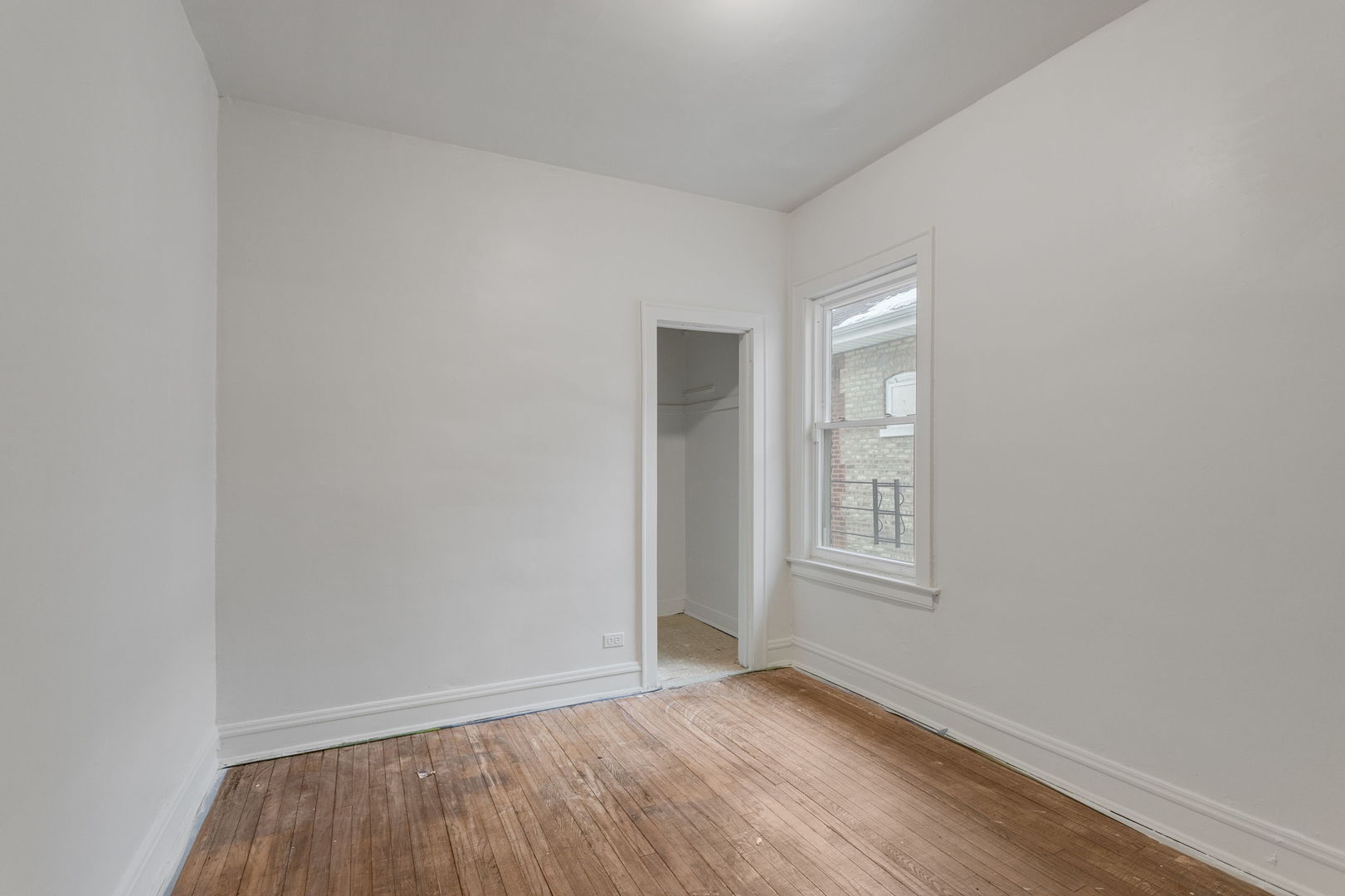 1404 West 97th Street Chicago, IL 60643 - Photo 9 of 13 a view of an empty room with wooden floor and window