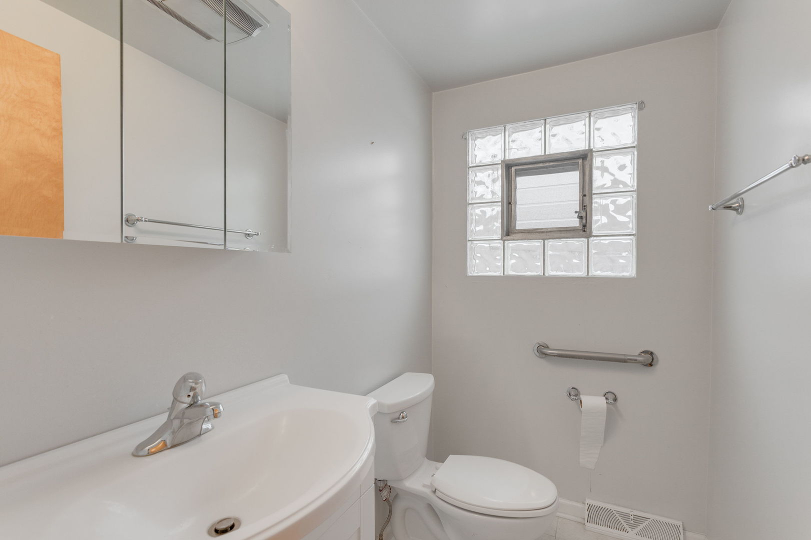 1404 West 97th Street Chicago, IL 60643 - Photo 10 of 13 a bathroom with a sink a toilet and vanity