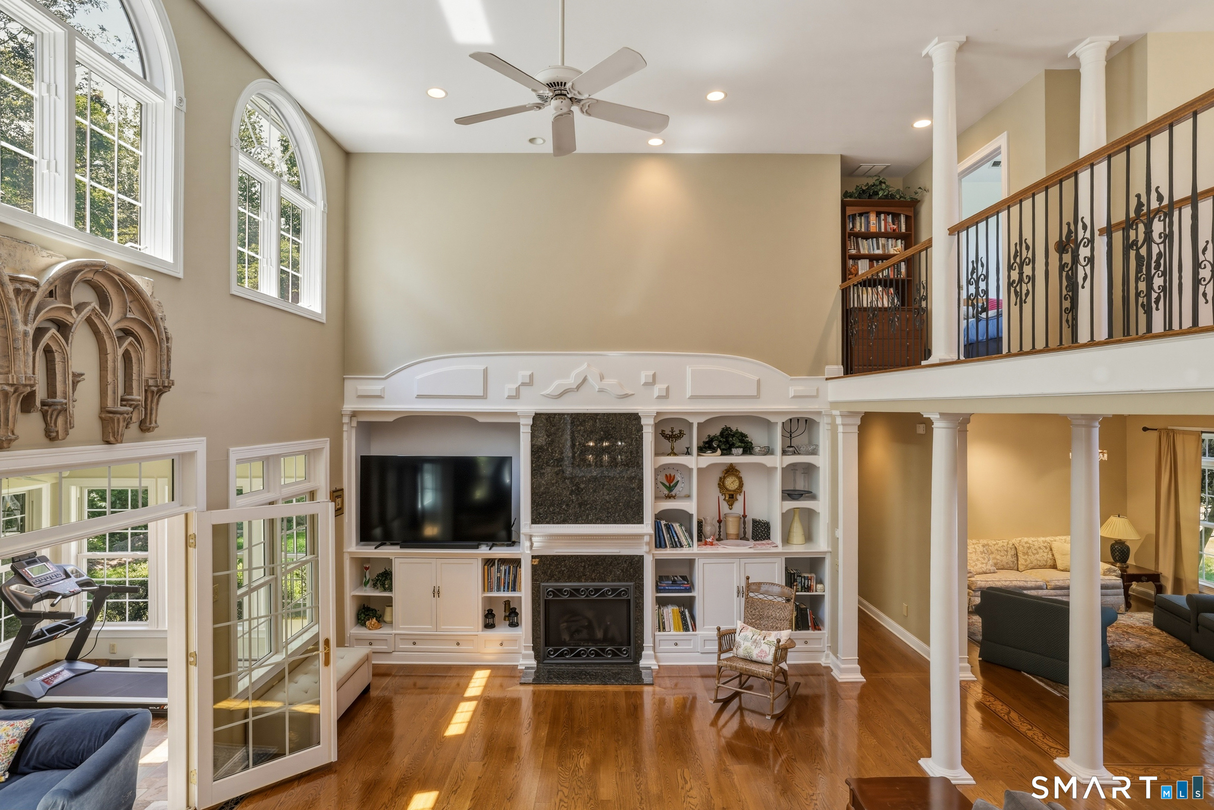 122 Lower Road Guilford, CT 06437 - Photo 10 of 40 A gas fireplace serves as a warm focal point, while French doors open to a year-round sun porch, creating a seamless indoor-outdoor connection ideal for relaxing and entertaining.