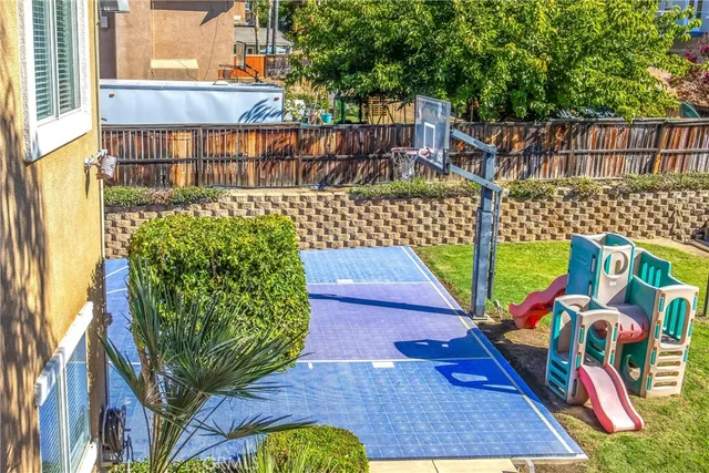 a view of a swimming pool with a garden and patio