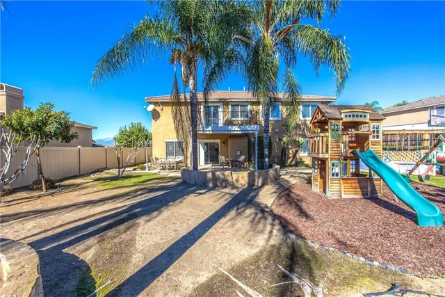 a view of a backyard with a patio and swimming pool