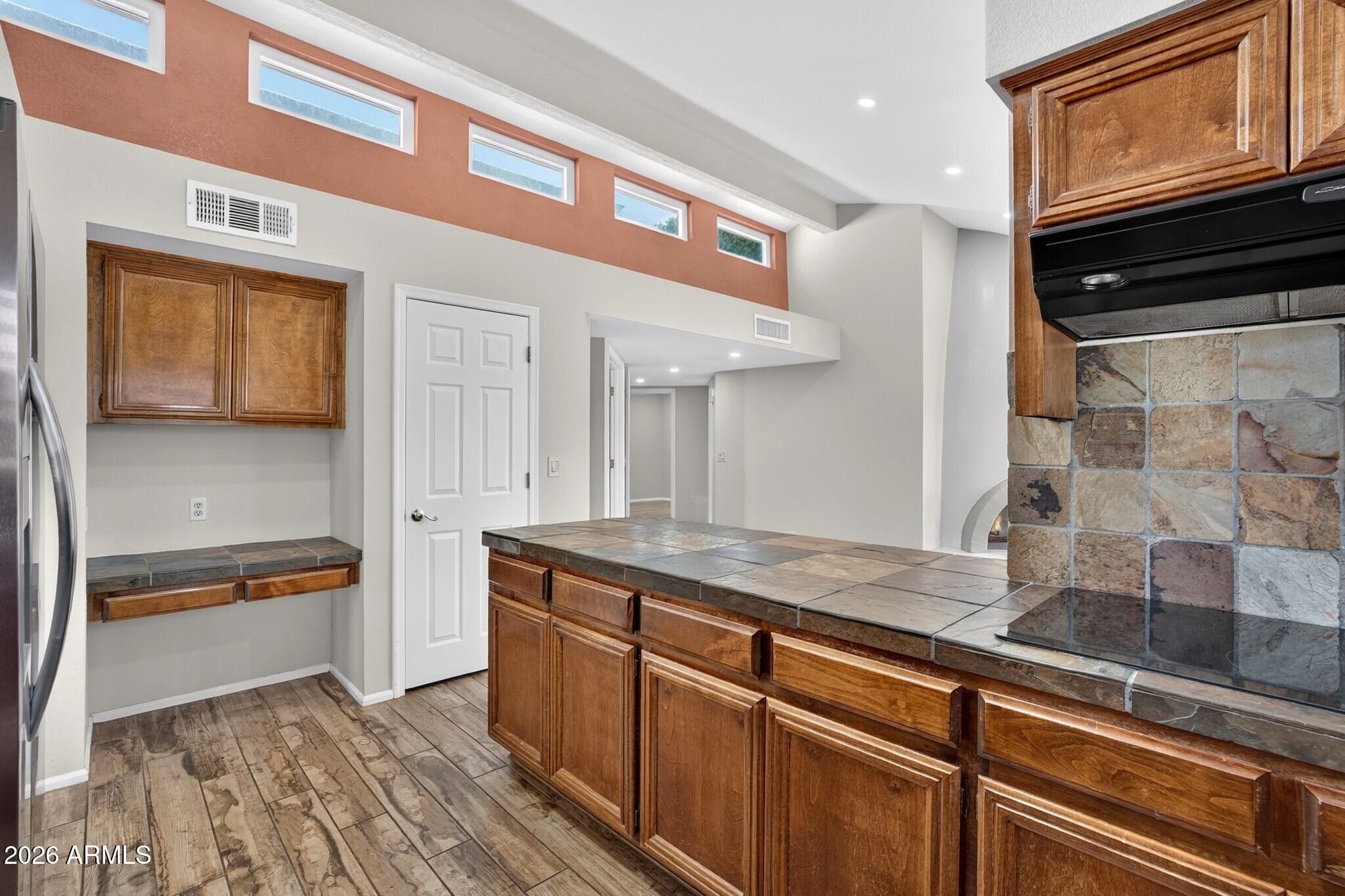 4615 East Monte Way Phoenix, AZ 85044 - Photo 34 of 35 a kitchen with granite countertop stainless steel appliances and wooden cabinets