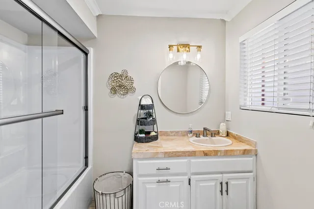 a bathroom with a granite countertop sink toilet and a mirror
