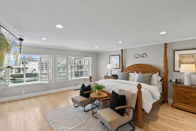 a bedroom with bed and a large window