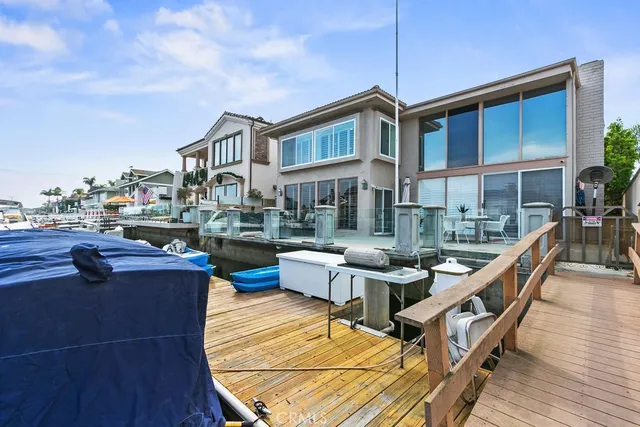 a view of a patio with couches chairs and wooden floor