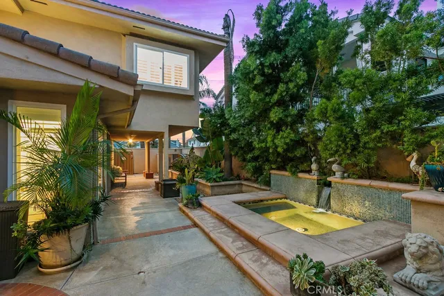 a view of a backyard with plants and a patio