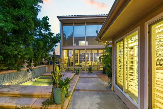 a view of a patio with chair and tables back yard of the house