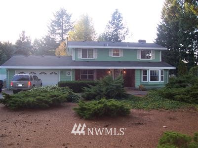18433 Nutmeg Street Southwest Rochester, WA 98579 - Photo 1 of 1 a front view of a house with garden