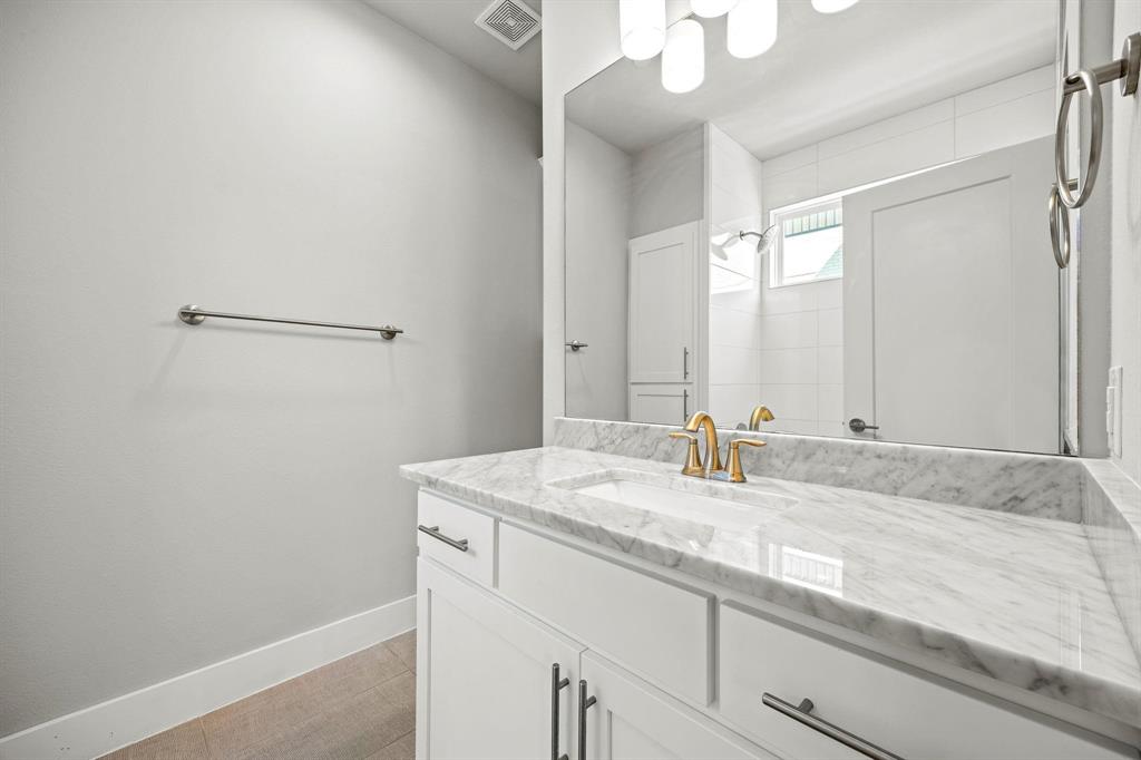 4690 Monarch Street, Unit 20 Dallas, TX 75204 - Photo 18 of 26 a bathroom with a granite countertop sink and a mirror