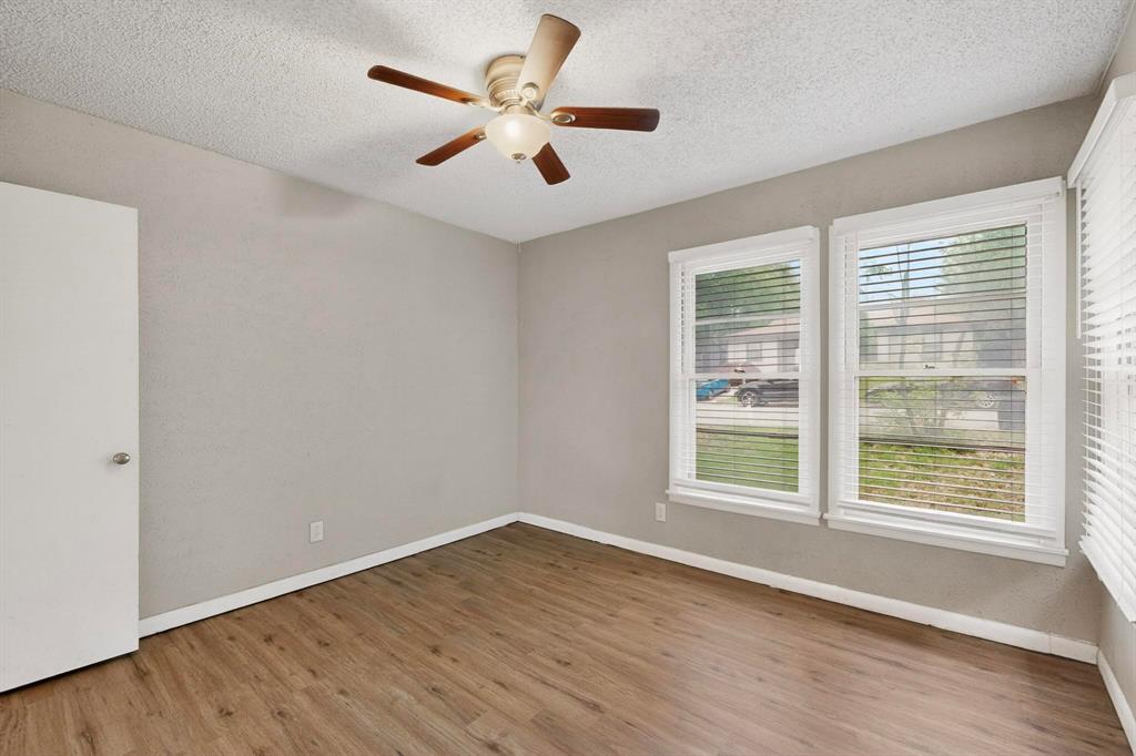 4508 Rutland Avenue Fort Worth, TX 76133 - Photo 26 of 36 an empty room with wooden floor and windows