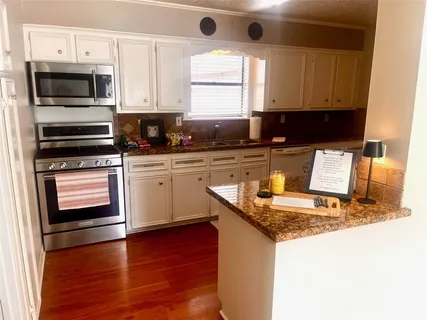 a view of a back yard of the house with a street