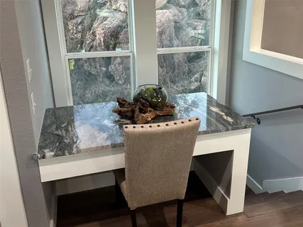 a dining room with furniture and wooden floor