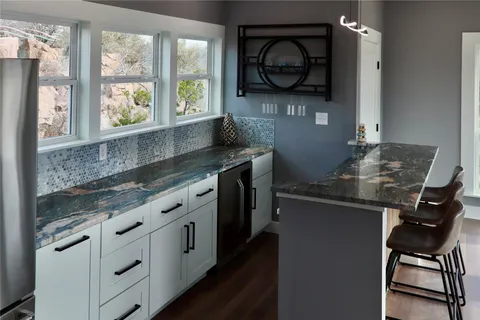 a kitchen with stainless steel appliances granite countertop a sink and a stove