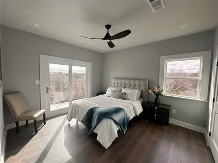 a bedroom with a bed and large window