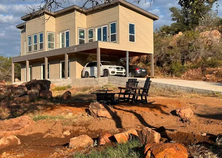a front view of a house with a yard outdoor seating and barbeque oven