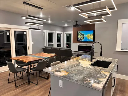 a view of a dining room with furniture and a flat screen tv