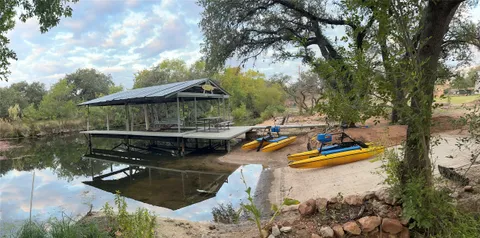 a view of a wooden deck and lake view