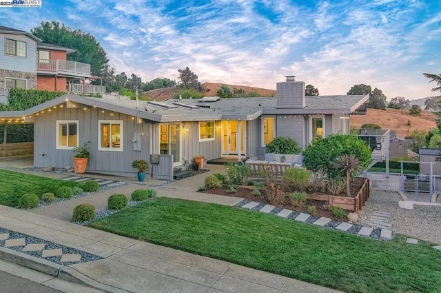 a front view of a house with garden
