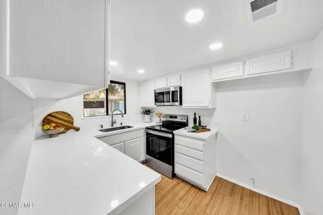 a kitchen that has a sink and a stove