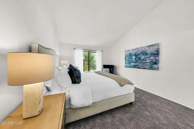 a bedroom with a bed and window