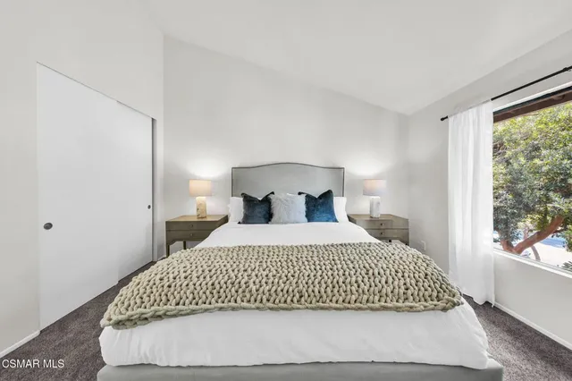 a bedroom with a bed and chair