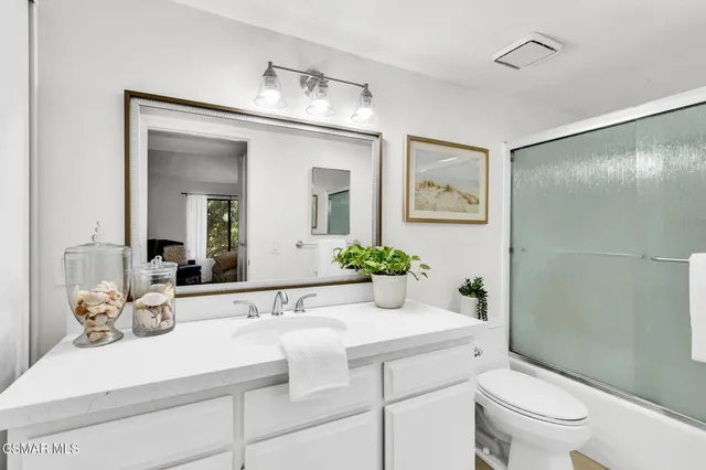 a bathroom with a shower and a sink