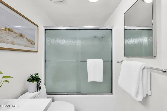 a bathroom with a sink a vanity and mirror