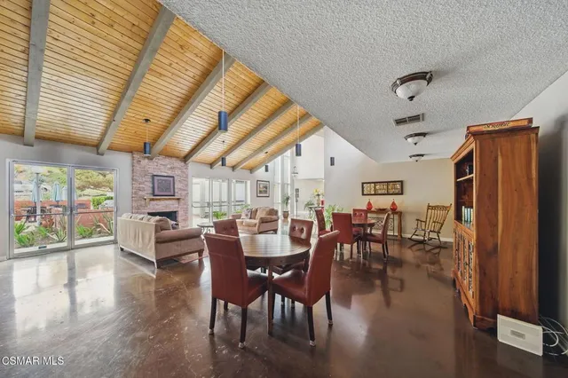 a view of a livingroom with workspace and large windows