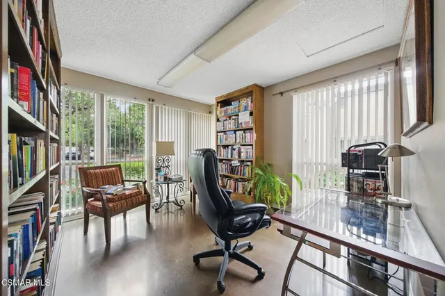 a room with pool table and windows
