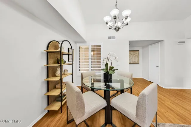 a view of a dining room with furniture and a chandelier