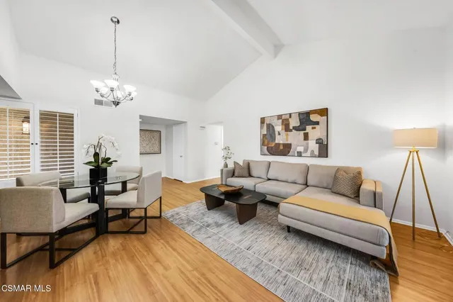 a living room with furniture and a chandelier