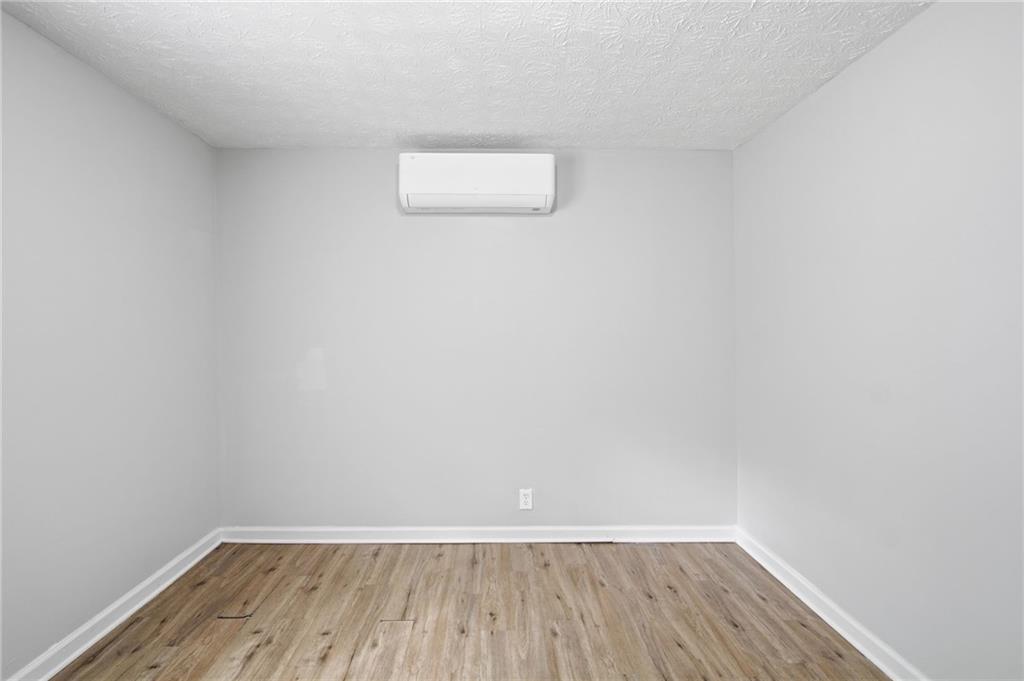 741 Roscoe Davis Road Monroe, GA 30656 - Photo 11 of 28 a view of a room with wooden floor and white walls