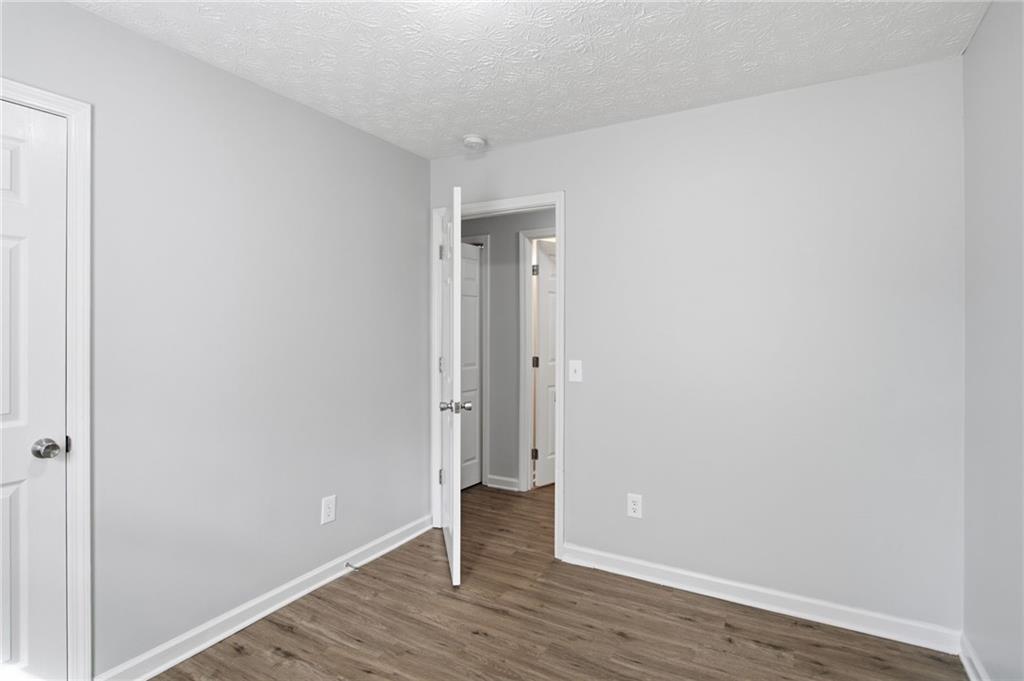 741 Roscoe Davis Road Monroe, GA 30656 - Photo 15 of 28 a view of an empty room with wooden floor