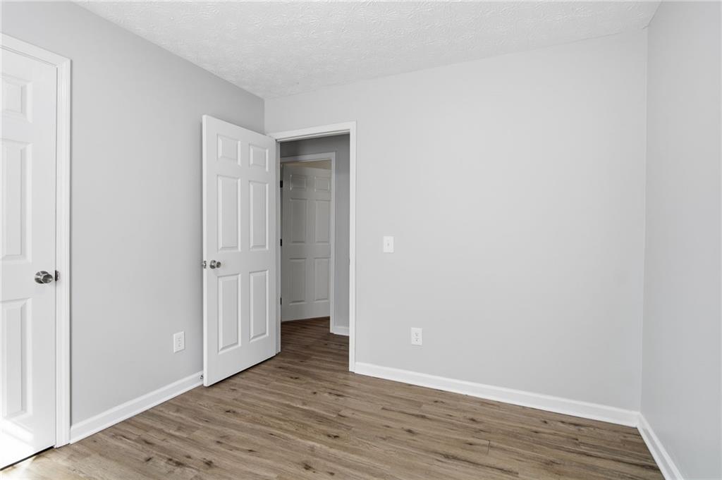 741 Roscoe Davis Road Monroe, GA 30656 - Photo 17 of 28 a view of an empty room with wooden floor