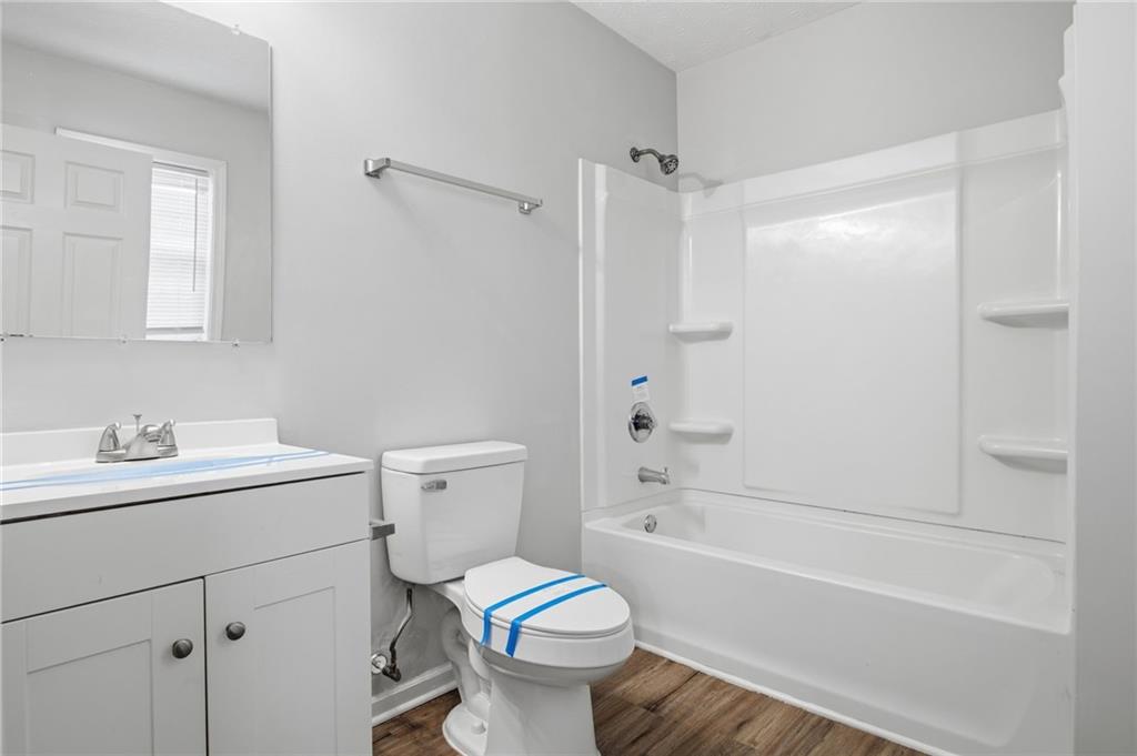741 Roscoe Davis Road Monroe, GA 30656 - Photo 22 of 28 a bathroom with a sink toilet vanity and shower