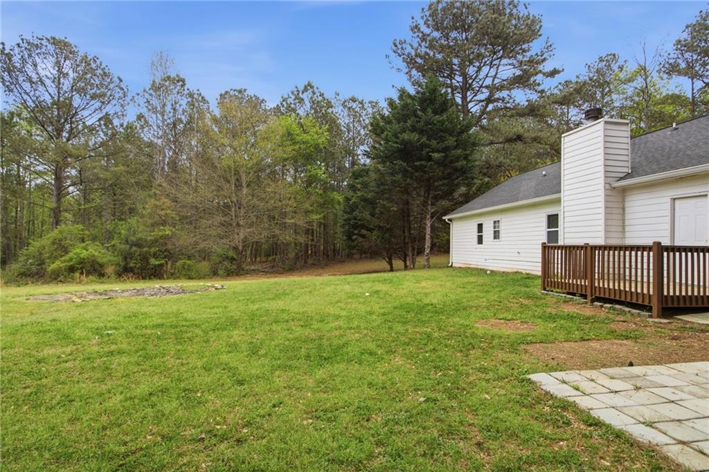 741 Roscoe Davis Road Monroe, GA 30656 - Photo 27 of 28 a backyard of a house with plants and large trees