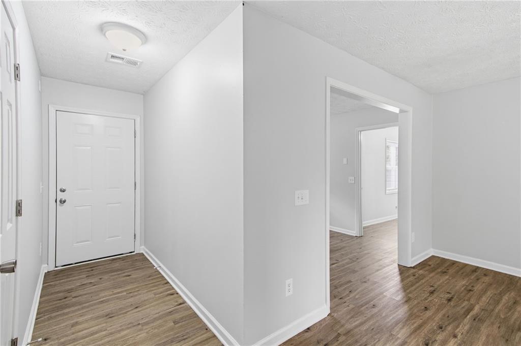 741 Roscoe Davis Road Monroe, GA 30656 - Photo 4 of 28 a view of a hallway with wooden floor