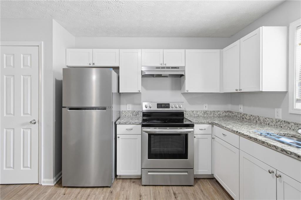 741 Roscoe Davis Road Monroe, GA 30656 - Photo 8 of 28 a kitchen with cabinets and stainless steel appliances