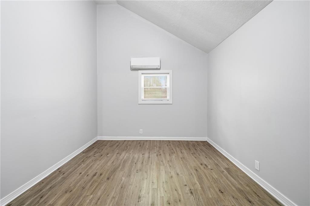 741 Roscoe Davis Road Monroe, GA 30656 - Photo 9 of 28 a view of a room with wooden floor and window