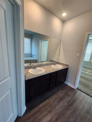 a bath tub sitting in a bathroom next to a window