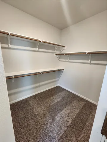 a view of a big building with a big yard and large trees