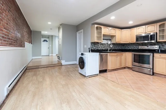 a kitchen with stainless steel appliances granite countertop a stove and a sink