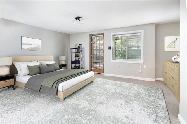 a spacious bedroom with a bed and a window