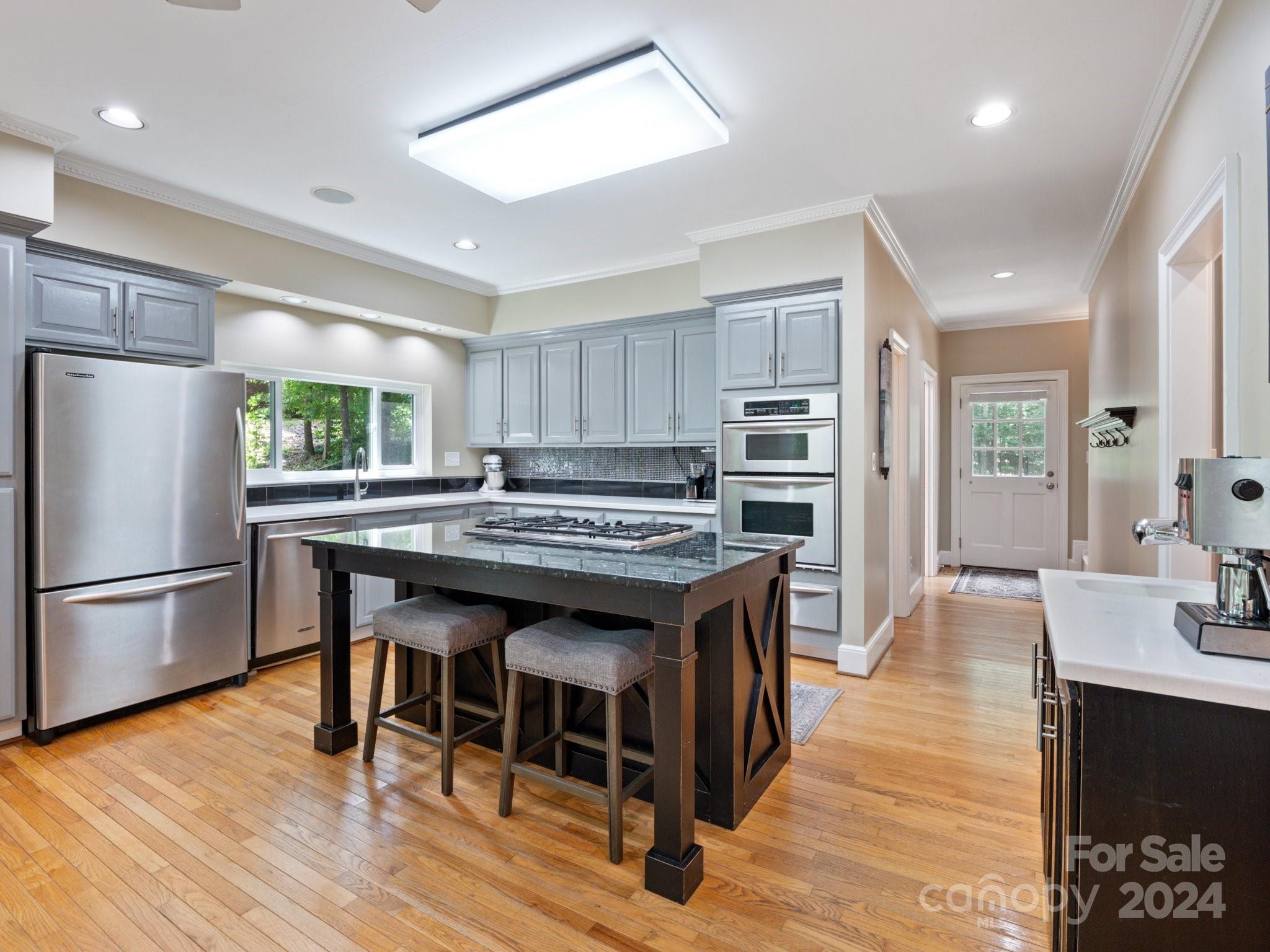 1971 Tara Trail Lancaster, SC 29720 - Photo 16 of 48 a kitchen with stainless steel appliances granite countertop a stove refrigerator and a fireplace