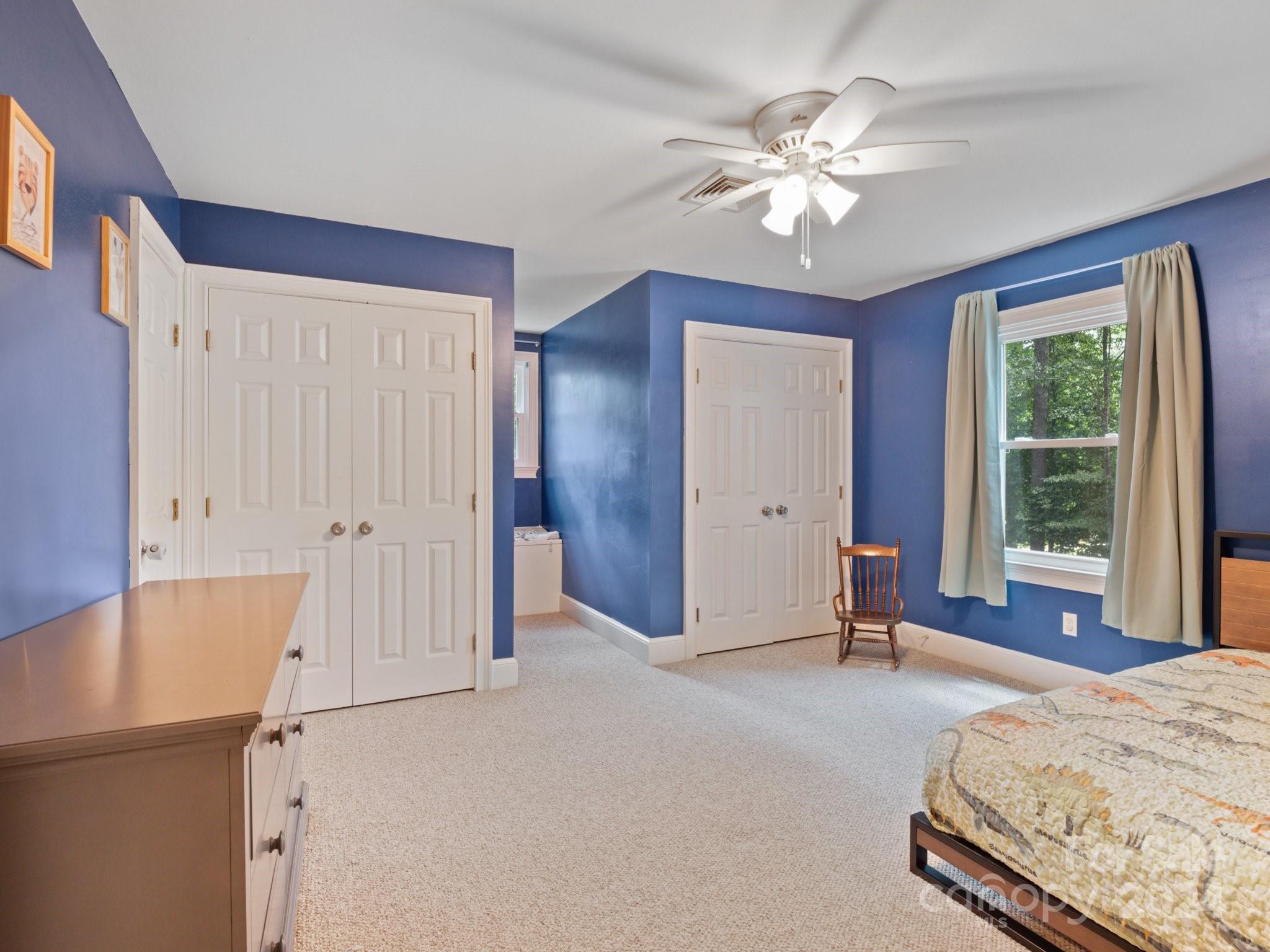 1971 Tara Trail Lancaster, SC 29720 - Photo 30 of 48 a spacious bedroom with a bed and a chandelier