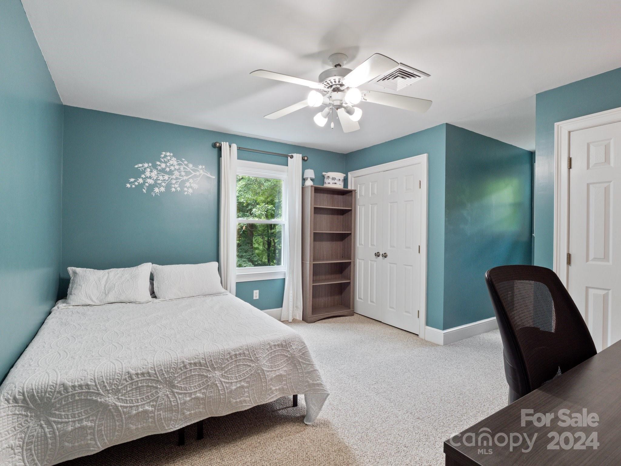 1971 Tara Trail Lancaster, SC 29720 - Photo 34 of 48 a bedroom with a large bed and a chandelier